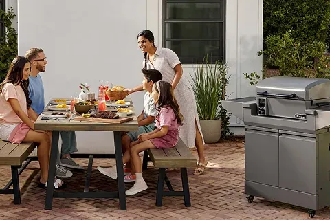 family-sitting-outside-by-tytus-pellet-grill